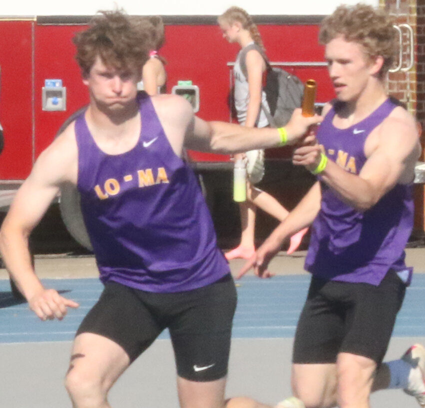 Logan-Magnolia's Evan Roden takes the baton from Cael Wallis in the first exchange of the 4 x 200 m relay, as the Panthers earned a Class 1A, eighth place state medal.