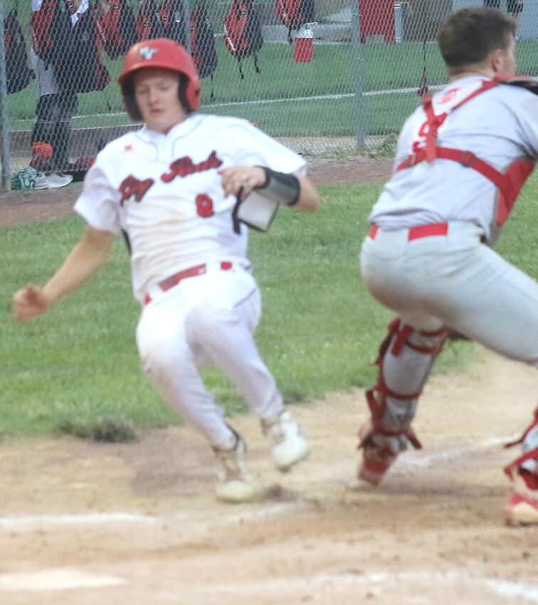 Missouri Valley's Dylan Davis (8) slides in safely ahead of the tag in Western Iowa Conference action on June 17 against Audubon.