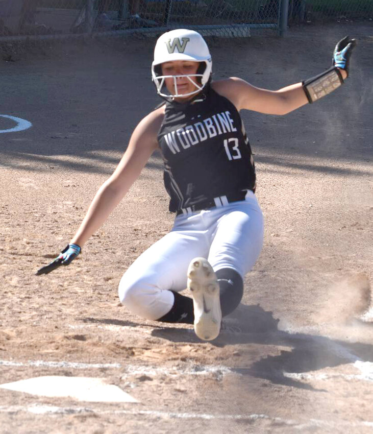 Woodbine's Elise Olson slides in safely after a passed ball in Rolling Valley Conference play last week.  The Tigers will host the Class 1A Regional Tournament on July 10 in Woodbine.