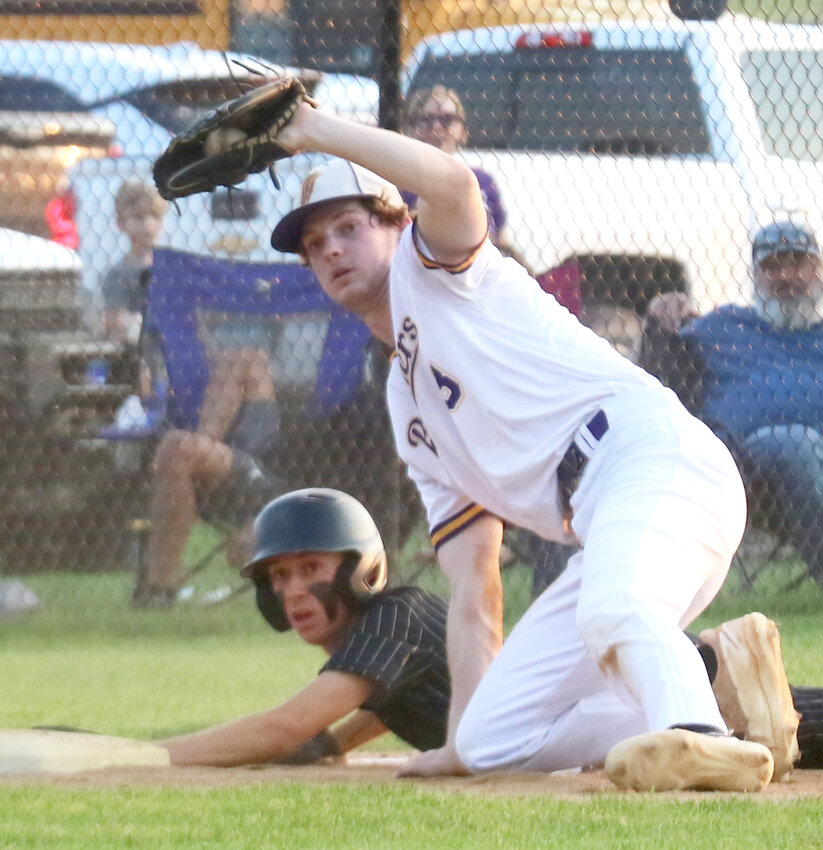 Logan-Magnolia Evan Roden shows the umpire the ball after the tag out in the Class 1A District Semifinal on July 9 at Woodbine.
