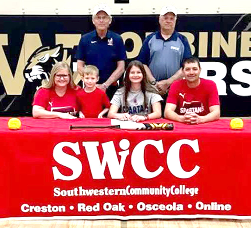 Woodbine senior Jersey Gray (front, center) signed her letter of intent to continue playing college softball at Southwestern Community College (Creston) back in May.  Shown in the front row, Kelli Gray (mom), Waylon Gray (brother), Jersey Gray, Joe Gray (dad).  Back row, Southwestern Head Softball Coach Danny Jensen, Southwestern Assistant Softball Coach Dan Gibbons.