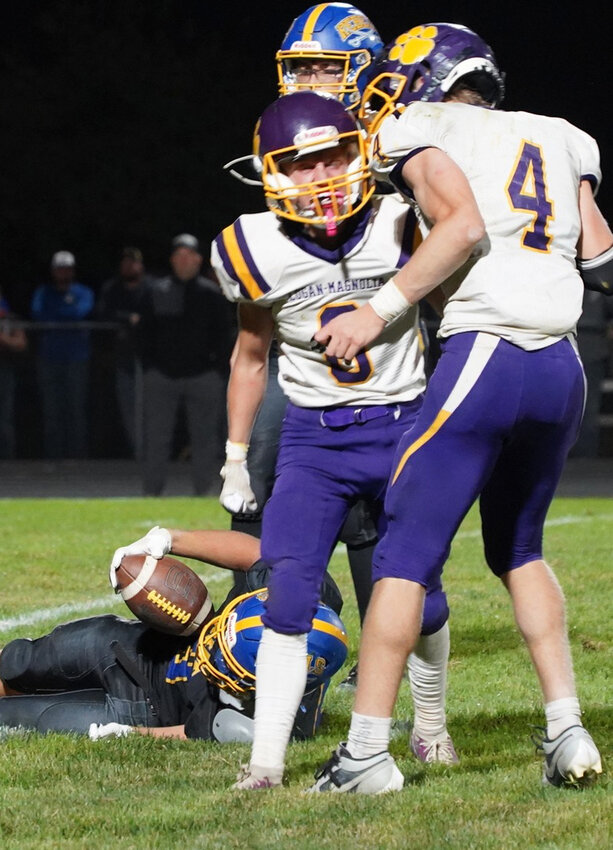 Logan-Magnolia's Crosby Yoder (8) and Ashton Peszulik (4) celebrate after getting the stop on the two point conversion with :30 seconds remaining in the fourth quarter on Oct. 4 at Sloan.