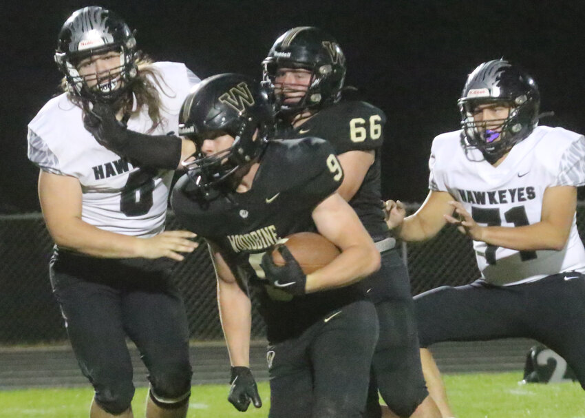 Woodbine's Micah Moores (9) gets past West Harrison's Abe Pavlik (6) and Julian Rivas (71) in 8-Man, District 1 action on Oct. 4 at Woodbine.