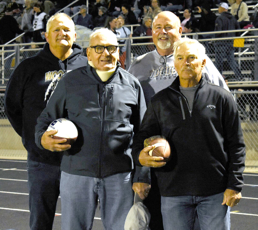 A combined 75 years of high school football experiences graced the Woodbine sidelines, and helped guide the Tigers to the 1997 Class A State Finals.  They were honored at the halftime of the regular season home finale on Oct. 18 in Woodbine.   They include (from left) Dink Alvis, Marshall Scichilone, Ty Knott, Jim Mullenix.