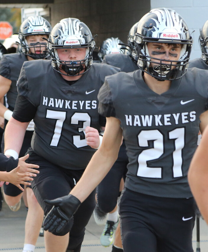 West Harrison seniors Taven Hussing (21) and Jason Barry (73) charged onto the field one last time in theinal home game of the season on Oct. 24 vs. Sidney.