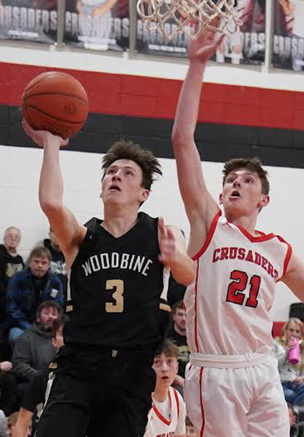 Woodbine's Xander Johnson takes the ball past his opponent in Rolling Valley Conference play on Feb. 4 at Coon Rapids.  The Tigers open up Class 1A District Tournament play on Feb. 17.