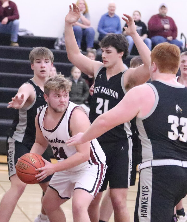 West Harrison's Blake Lawrenson, Nolan BIrdsall and Jason Barry (33) surround the Exira/Elk Horn Kimballton player in Class 1A District action on Feb. 14 at Elk Horn.