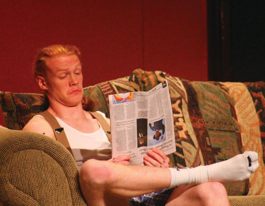 Adam Meadows, who portrayed Tony Nale in the play, is likely very distracted from what his next line is as he enjoys the newspaper.