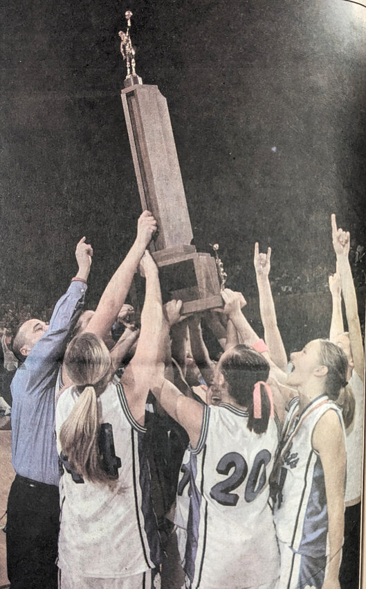 The 2005 Class 1A State Champions raise their trophy high as they gather on the floor of Veterans Auditorium. This is the first state title for the Charter Oak-Ute girls basketball team. The last time the girls team made a state appearance was in 1952 by the Charter Oak Eaglettes.