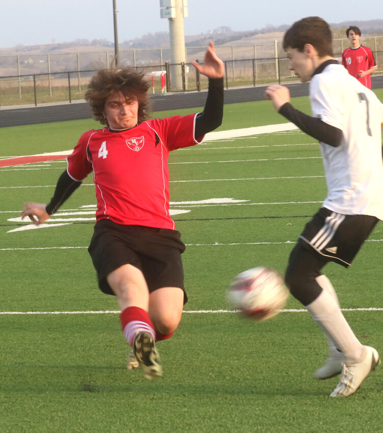 Missouri Valley's Aaron Gschwend (4) sends the ball past the defender in the Big Reds win over Atlantic on April 8.