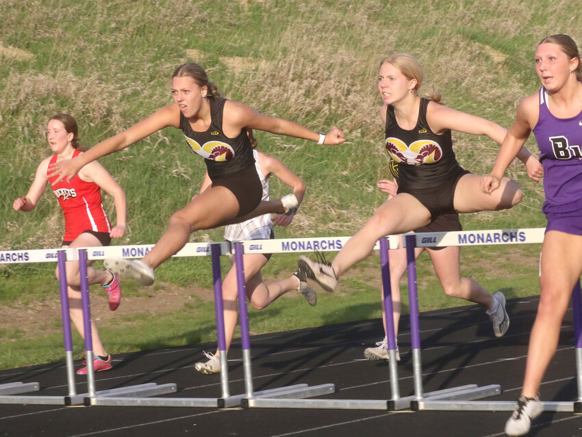 Marley Scott and Renee Oberruter compete against each other in the 100 m. hurdles.