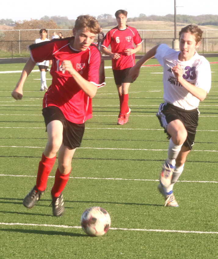 Missouri Valley's Dominick McDowell (14) and Logan-Magnolia's Liam Hunter (33) chase down the loose ball in non-conference action on May 5 at Missouri Valley.