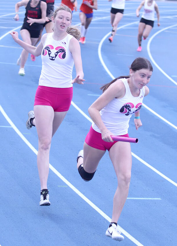 Trista Ohlmeier hands the baton off to her sister, Taya, in the spring medley.