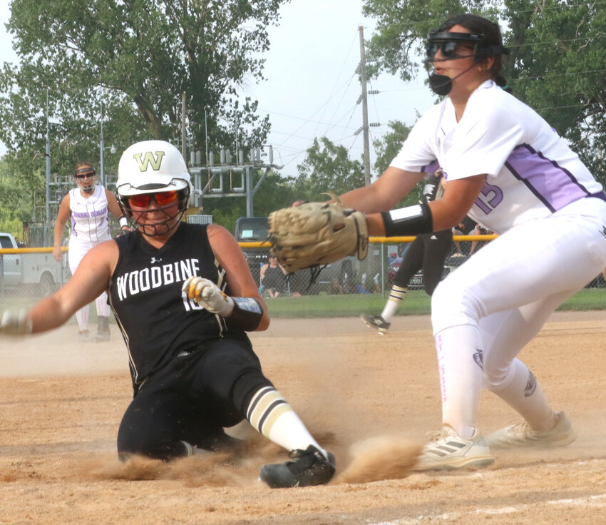 Woodbine's Leena Boettger slides in safely ahead of the tag by Boyer Valley's Sierra Falkena in Rolling Valley Conference play on June 11 in Dow City.