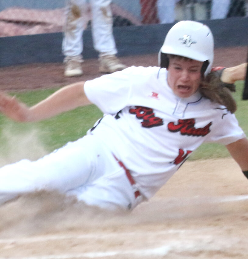Missouri Valley's Noah Cox slides safely in ahead of the tag in the Big Reds victory over Audubon on June 9.