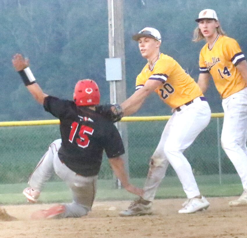 Logan-Magnolia's Jason Kastner (20) tags out the advancing Missouri Valley baserunner in Western Iowa Conference baseball action on June 10 in Logan.