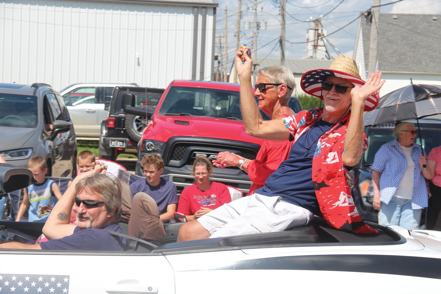 Grand Marshals Gretchen and Virgil Peterson, seated in the back of the car, were wheeled around in last year's parade by Wade and Theresa Lawson.