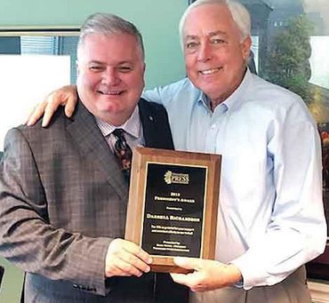 Darrell Richardson (left) receives the 2019 President's Award from outgoing Tennessee Press Association president Doug Horne.