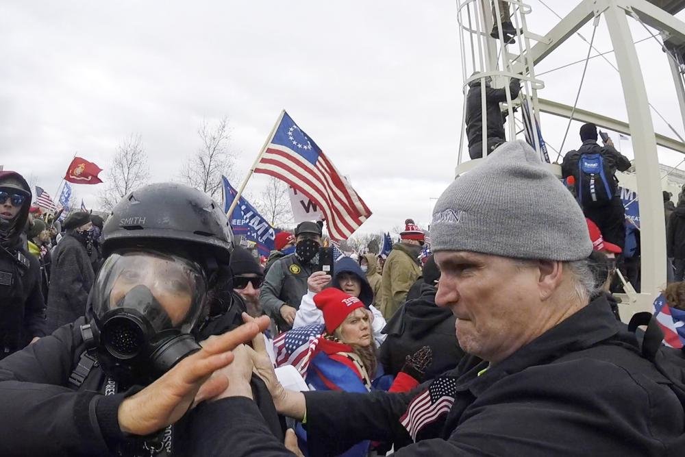In this Jan. 6, 2021, image from video, Alan William Byerly, right, is seen allegedly attacking an AP photographer during a riot at the U.S. Capitol in Washington. (AP Photo/Julio Cortez)