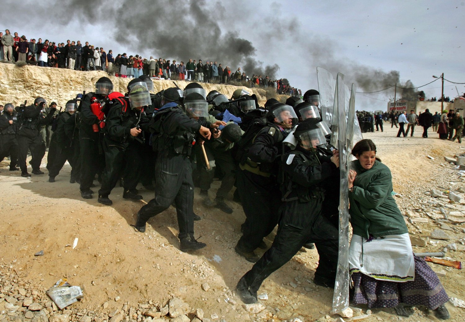 This Pulitzer Prize-winning photo of a Jewish settler challenging Israeli security officers in the West Bank settlement of Amona, Feb. 1, 2006, will be among the first NFTs available on AP’s NFT marketplace. (AP Photo/Oded Balilty)