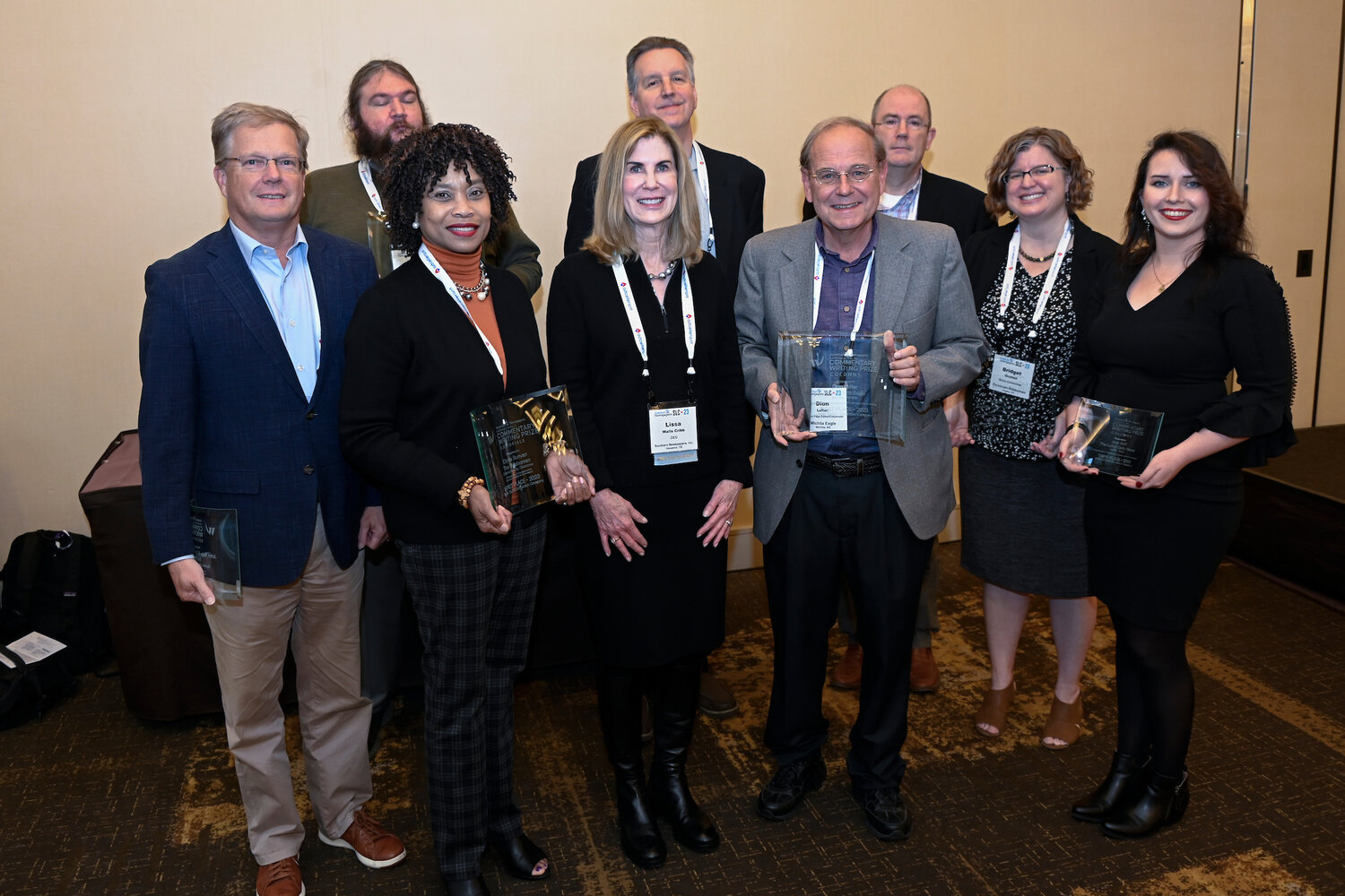 Pictured with Lissa Walls Cribb, CEO, of Southern Newspapers, (front center) who presented this year's Carmage Walls Commentary Prizes are: (left to right - front row): David Woronoff, The Pilot, Southern Pines, North Carolina; Clytie Bunyan, The Oklahoman; Dion Lefler, The Wichita Eagle; Bridget Grumet, Austin American-Statesman; and Jess Huff, Lufkin Daily News. Back row (left to right): Dave Coffey, The Berkshire Eagle; Dave Stafford, The Republic (Columbus, Indiana); and Brier Dudley, The Seattle Times (Photo by Matt Marton @martonphoto)