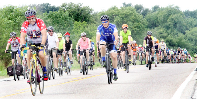 A crowd bikes into the Blue Grass Drive-In.