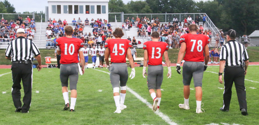 North Scott captains Nile McLaughlin, Mason Watts, Carson Rollinger and Brady Ernst take the field for the coin toss.