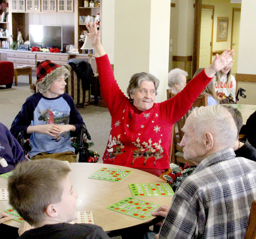 Germaine Wilmott shouts &quot;bingo&quot; at a table with students Collin Meinart and  Zander Pewe.
