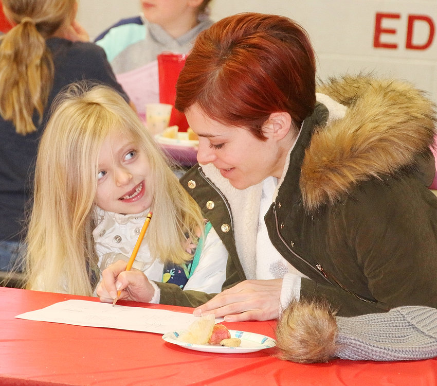 Scarlett Young smiles up at her mom, Sarah Carlin, as the two enjoy time together before school.