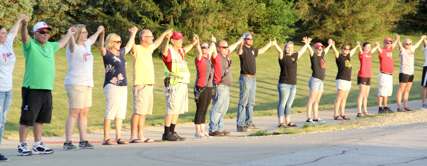 Trail walkers raise arms for the drone video of the Aug. 6 Night Out on the Eldridge-Long Grove trail.
