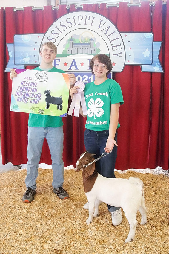 Julia Phillips showed the Reserve Champion Intermediate Bottle Goat. She's pictured with James Hepler.