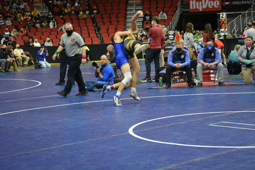 Drake Collins elevates his opponent in a match at the state wrestling tournament last year