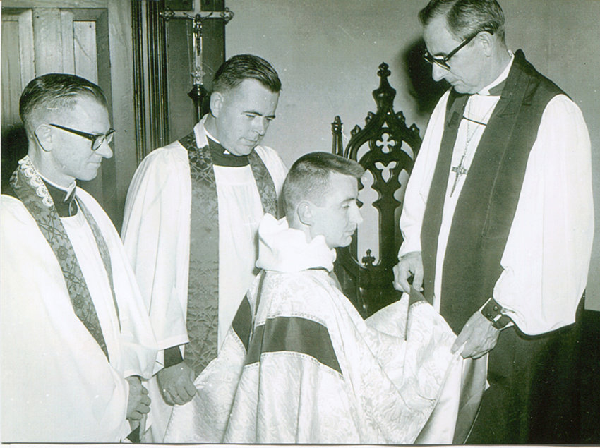 The Rev. Richard Anderson, kneeling, is pictured being ordained an Episcopal priest by Bishop Gordon V. Smith Dec. 21, 1961. The Very Rev. William Swift (left) of Trinity Cathedral in Davenport presented Father Anderson for ordination. The Rev. Harold Robinson of St. Paul&rsquo;s Church, San Diego, preached during the service.