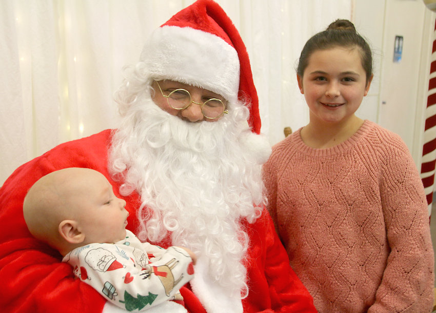 Five-month-old Hudson Wolfe makes his first Santa trip with Olivia Harms.