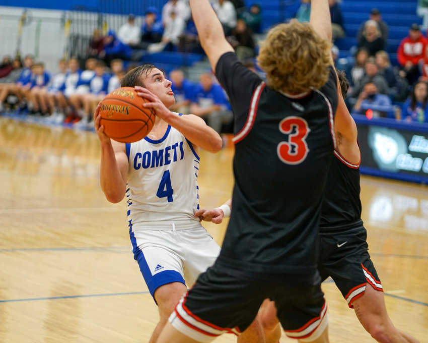 Caleb Wulf pulls up for a jumper against West Branch defenders.