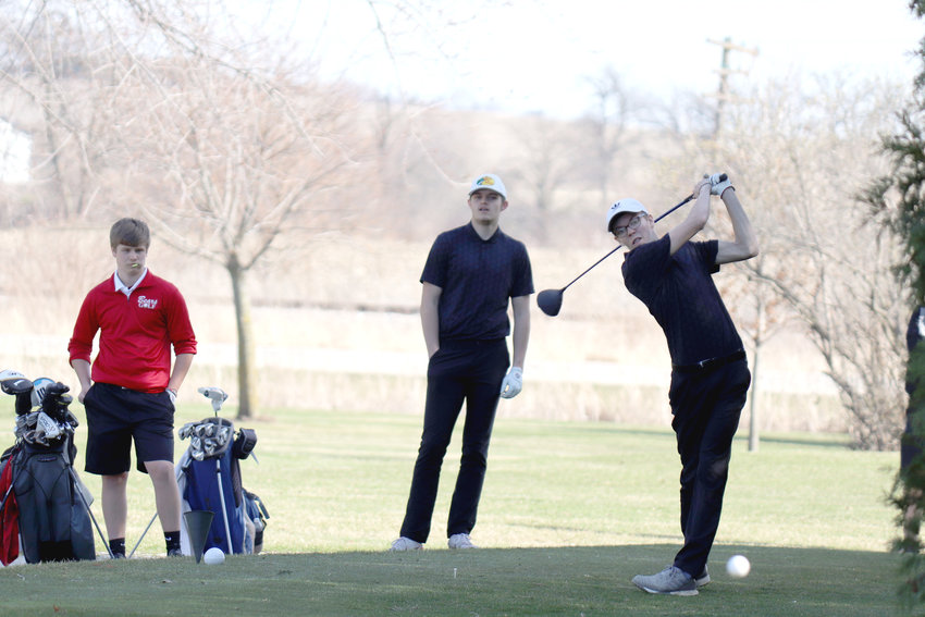 Tevin Miller, left, watches Tysen McKinley, right, tee off during the April 11 meet against West Branch at Wahkonsa Country Club.