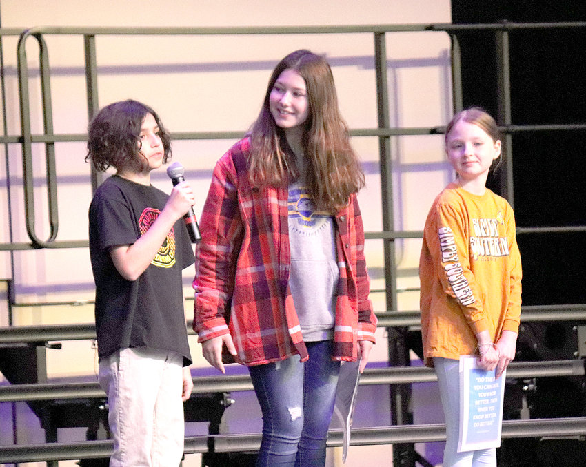 Emmett Marquez, Keeleigh McHugh, and Nevaeh Langley speak at the Leadership Day assembly.
