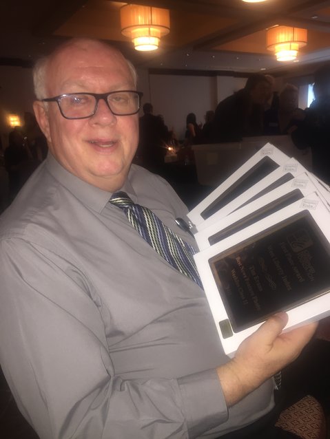 Index Editor Tim Evans shows the four first place awards won in the INA contest this year.
