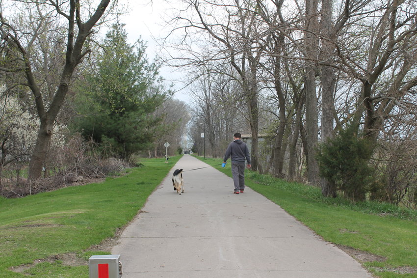 Dreams of more trails in West Liberty came up at the WeLead &quot;Destination Iowa&quot; grant proposal meeting, something Buddy and his owner, Dane Lovell, might find appealing, caught here taking a walk Monday evening on the Hoover walking/bike trail.