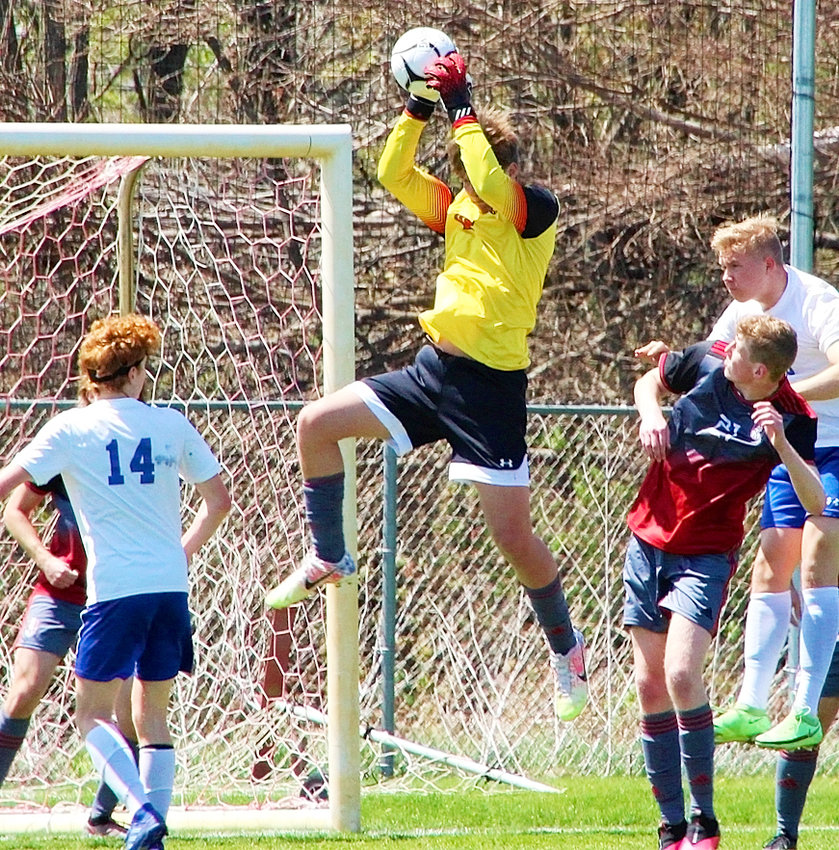 Lancer senior keeper Jakob Nelson goes high to thwart this Clear Creek-Amana shot on Saturday.