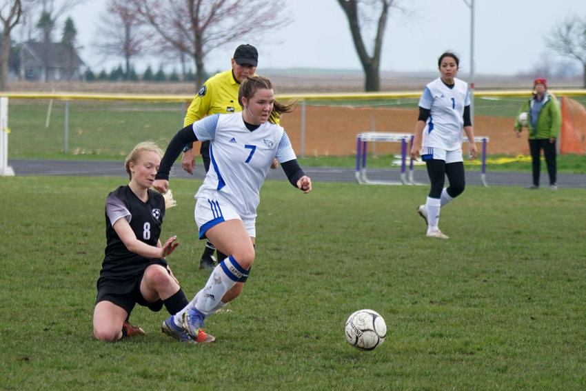 Sailor Hall shakes a defensive player to gain control of the ball. The girls play Monday in West Liberty in their first round of the state soccer playoffs against Wapello.