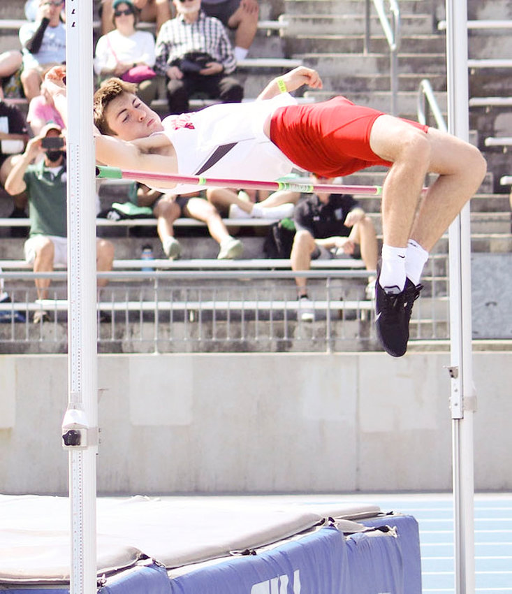 Sam Skarich clears the bar on his way to a state high jump title.