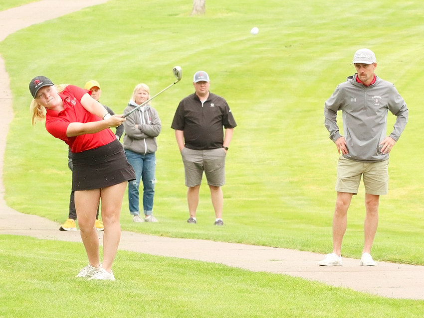 With her parents, Jolene and Jason, along with coach Collin Ellis watching, Lancer sophomore Kaycee Newman hit her approach on No. 14