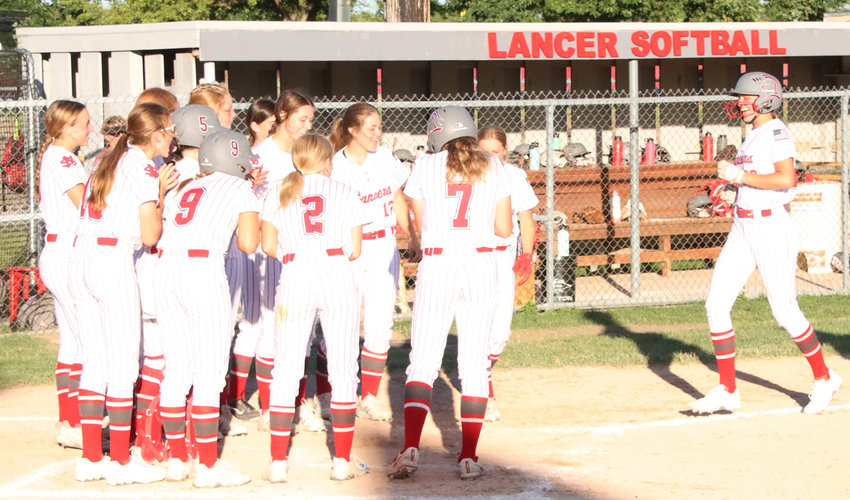 North Scott junior Maddy McDermott is greeted by her teammates after clubbing her second home run of the game in Friday's win over Marion