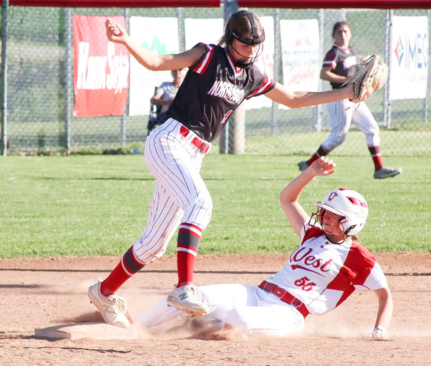 Lancer second baseman Rylie Robertson takes a throw from Adalynn Johnson to force Davenport West's Emmaly Maylum.