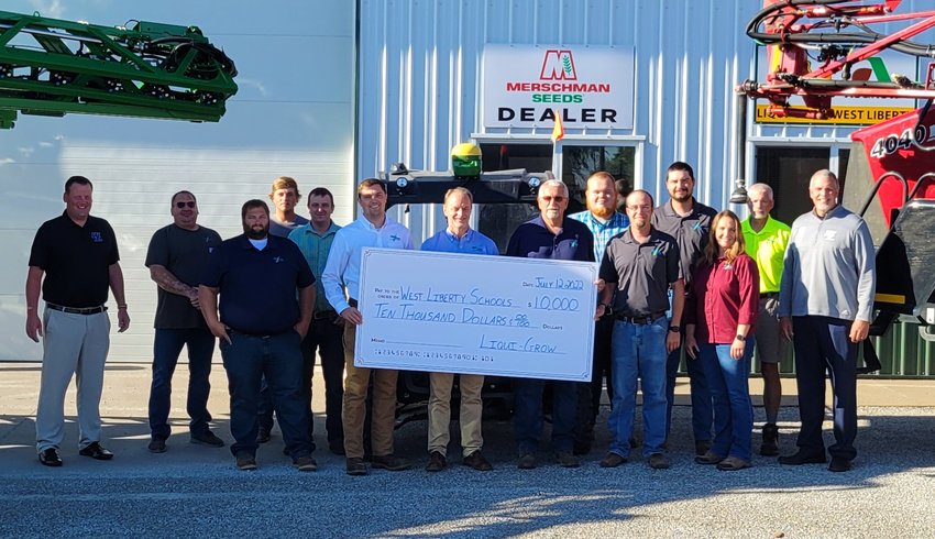 Employees from Liqui-Grow stand with the $10,000 donation check along with West Liberty Community School District Superintendent Shaun Kruger (right) last week.