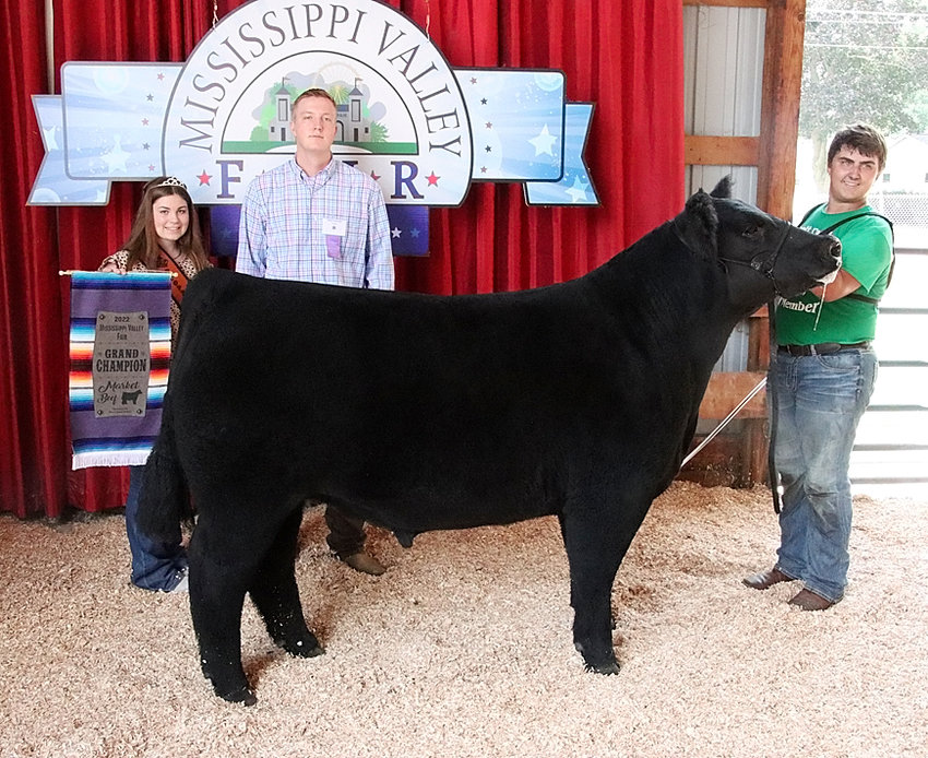 Brandon Benson showed the Grand Champion Market Steer that was also the Champion Crossbred. He's pictured with Scott County Beef Princess Makenna DeCap and judge Mitch Holcomb.