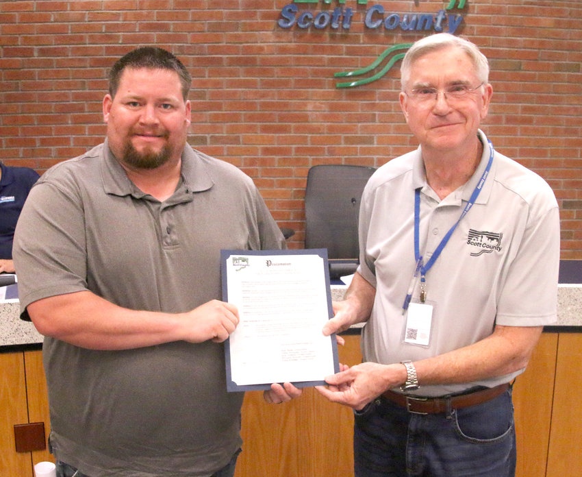Operating Engineers 150 business representative, Karl Darpeaux, left, accepts the labor union proclamation from Scott County Board Chairman Ken Beck.