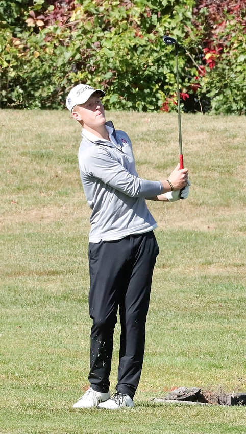 John Dobbe watches his approach shot on the 15th hole during the opening round of the state golf tournament.
