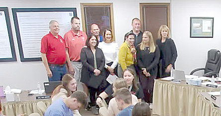 North Scott school board members pose with their first group of Lancer Pride honorees: From left: Board member John Maxwell, Lancer Boosters director Lynn Kilburg, high school counselor Anastasia Nikolopoulos, board member Frank Wood,  Armstrong teacher Carolyn Lewis, board chairman Joni Dittmer, board members Mark Pratt, Molly Bergfeld and Tracy Lindaman.